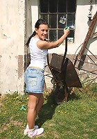 Sexy teen sitting in wheelbarrow