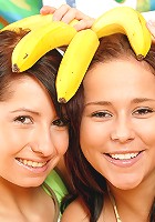 Teenie girls playing with bananas